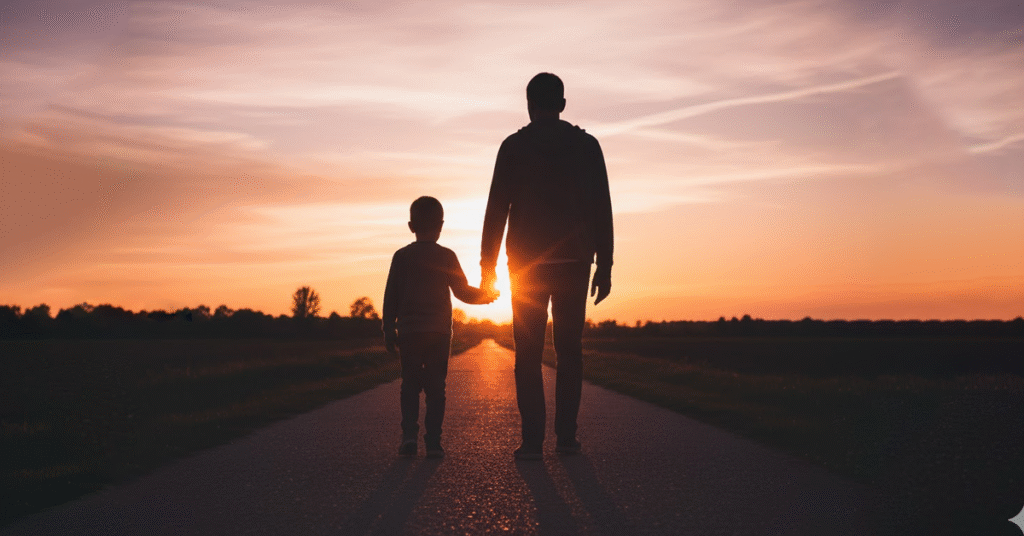 pai-e-filho-caminhando-juntos-de-maos-dadas-em-direcao-ao-horizonte-ao-por-do-sol-silhuetas-contra-ceu-colorido-laranja-e-rosa-1024x536 A Responsabilidade Paterna que Falta a Tantos Homens
